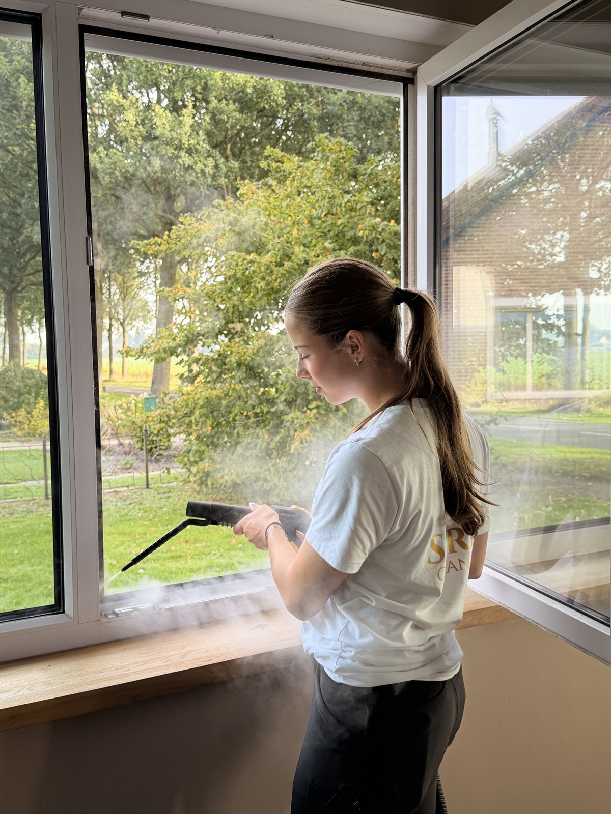 Glazenwasser van Strix Cleaning reinigt een raam van binnen met een stoomreiniger